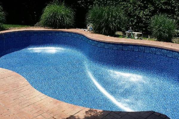 a newly installed perfect fit Garrett vinyl pool liner - Citadel Tile Courtyard Freeform