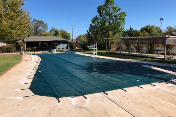 A Garrett pool safety cover over an inground pool