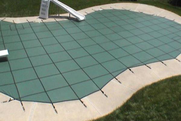 A Garrett pool safety cover over an inground pool