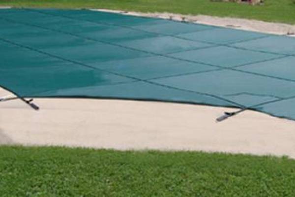 A Garrett pool safety cover over an inground pool