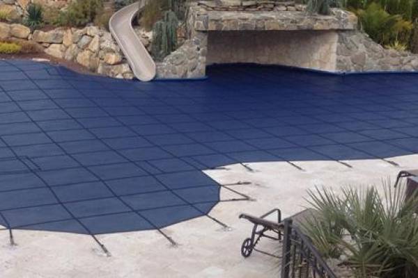 A Garrett pool safety cover over an inground pool