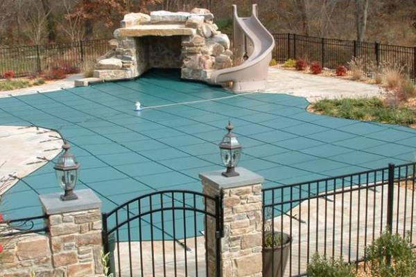 A Garrett pool safety cover over an inground pool