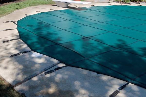 A Garrett pool safety cover over an inground pool