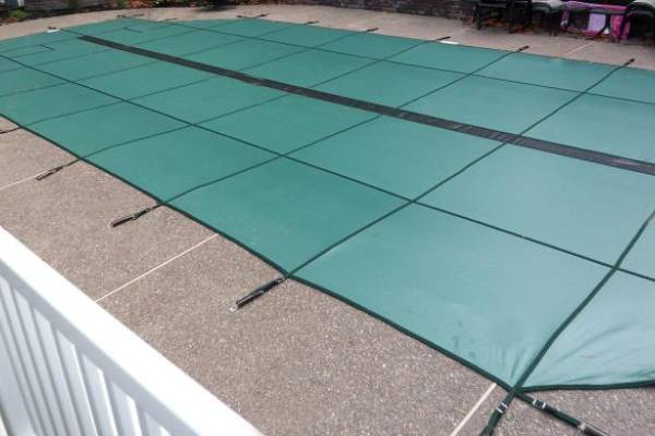 A Garrett pool safety cover over an inground pool