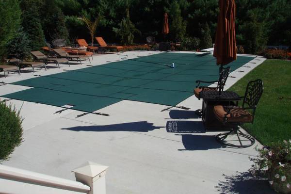 A Garrett pool safety cover over an inground pool