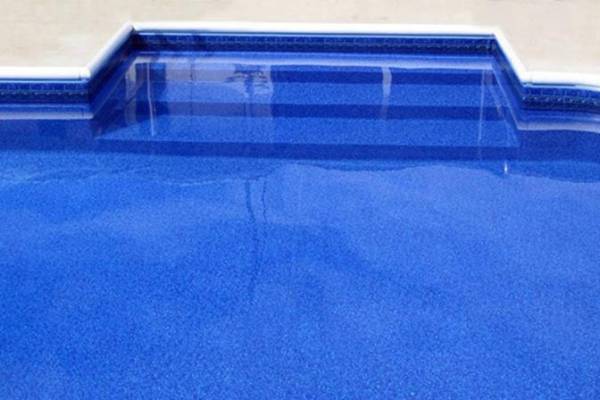 a recently installed in ground pool vinyl liner with stairs