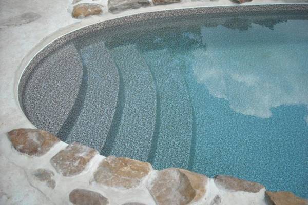 a recently installed in ground pool vinyl liner with stairs