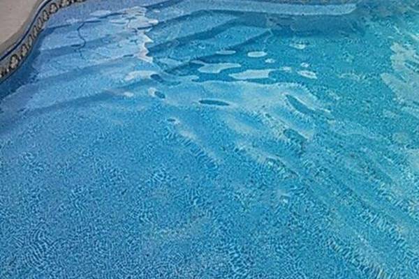 a recently installed in ground pool vinyl liner with stairs