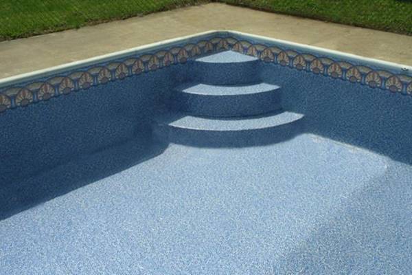 a recently installed in ground pool vinyl liner with stairs