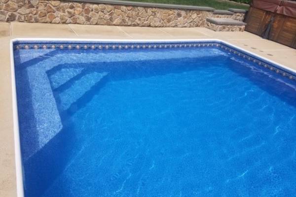 a recently installed in ground pool vinyl liner with stairs