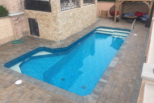 a recently installed in ground pool vinyl liner with stairs and special features