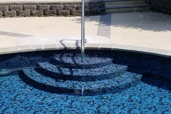 a recently installed in ground pool vinyl liner with stairs - Lal Anurag