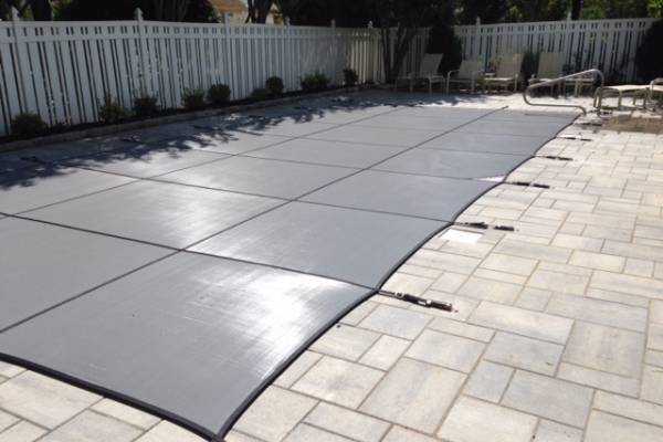 A Garrett pool safety cover over an inground pool - Melchiorre Gary Mesh Johnson