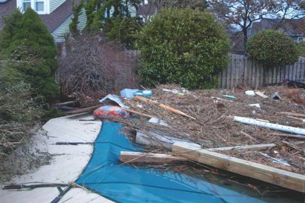 A Garrett pool safety cover over an inground pool