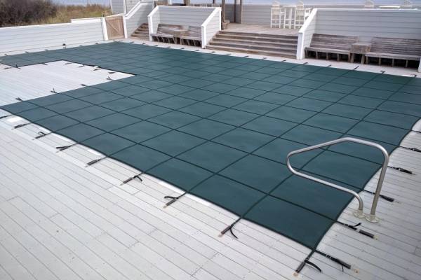 A Garrett pool safety cover over an inground pool