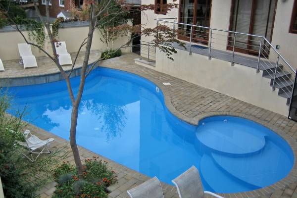 a recently installed in ground pool vinyl liner with stairs and special features
