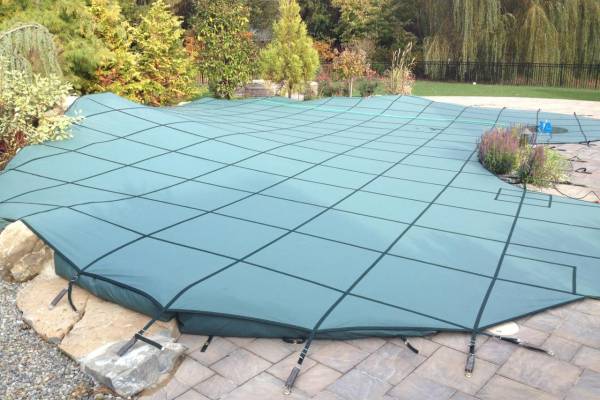A Garrett pool safety cover over an inground pool