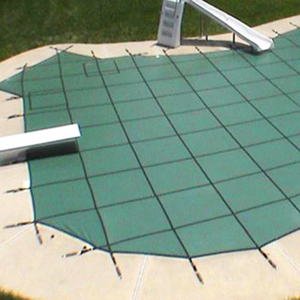 an in ground pool covered by a Garrett pool safety cover