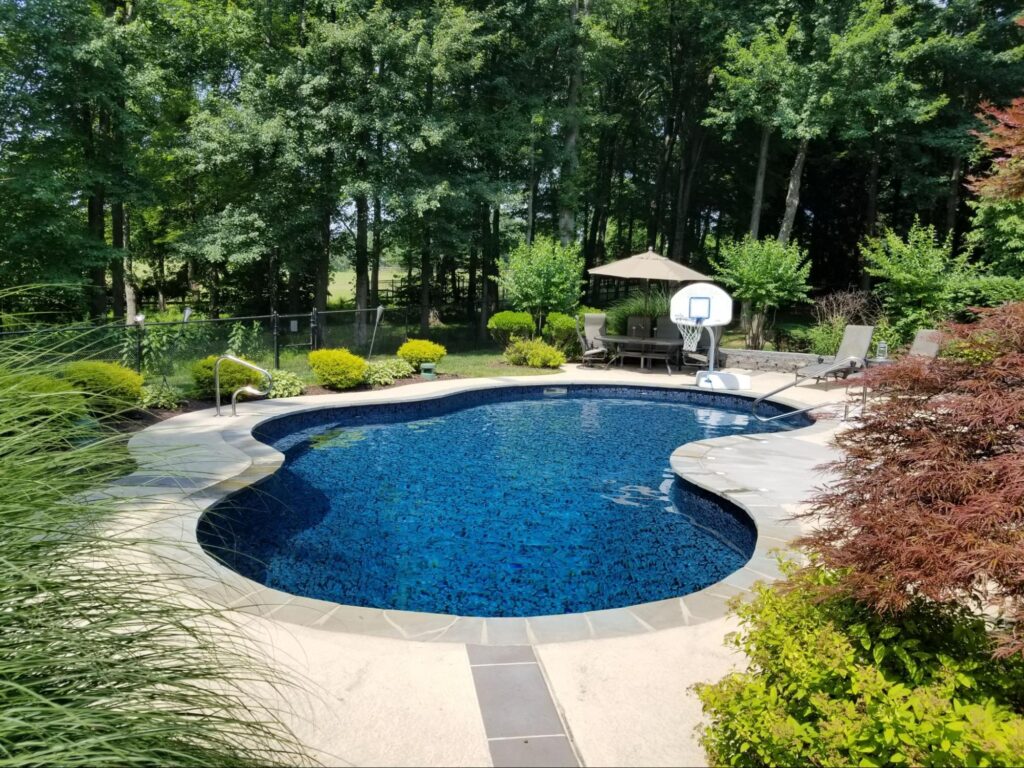 an inground pool featuring a vinyl pool liner by Garrett
