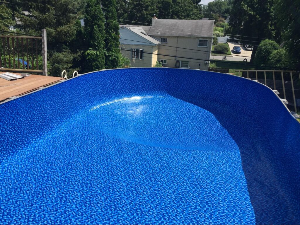 an inground pool featuring a vinyl pool liner by Garrett